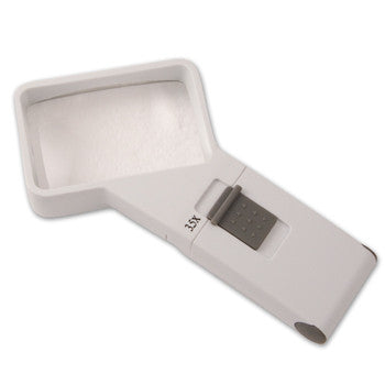 Lighted magnifier with 50mm X 75mm rectangular lens and slightly angled handle. 