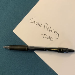 Pilot G-2 Retractable Gel Pen shown on a piece of white paper with the words "Gone Fishing -Dad" written to show bold, crisp, contrast.