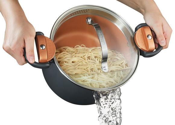 Gotham Lock Lid Pot with spaghetti inside. Image shows water being poured out of the pot.